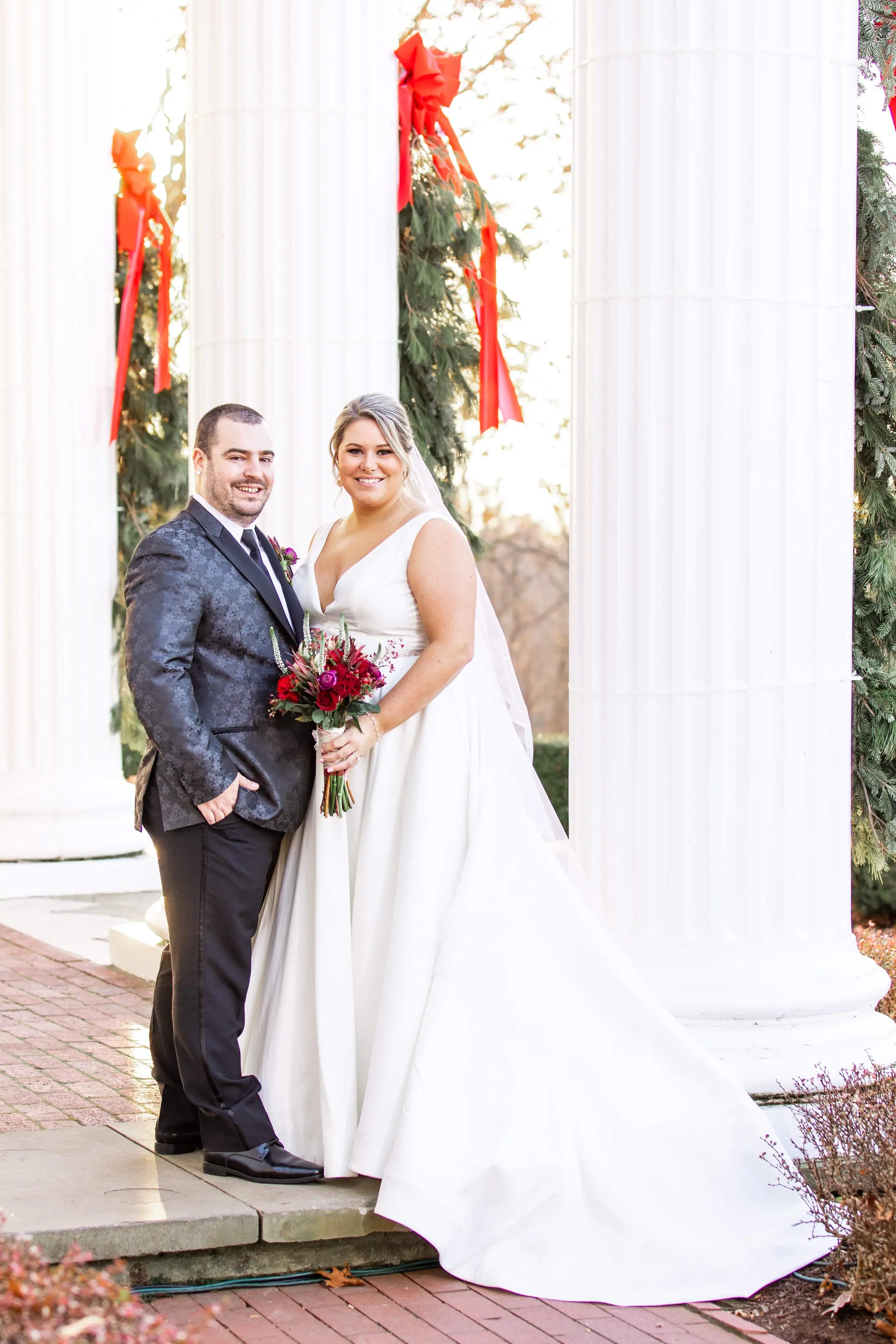 Zach and Allie on their wedding day in front of white columns
