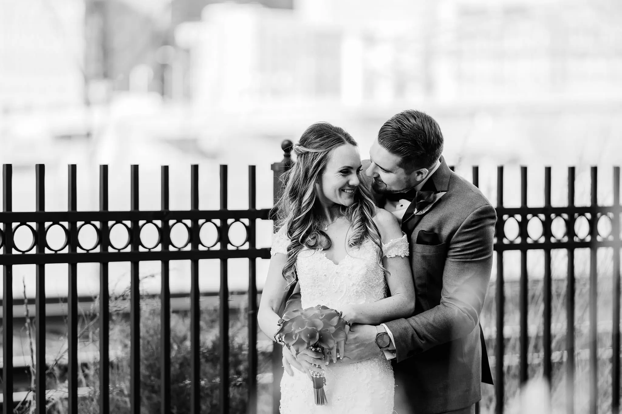 Dan and Emily smiling together in a black and white wedding portrait