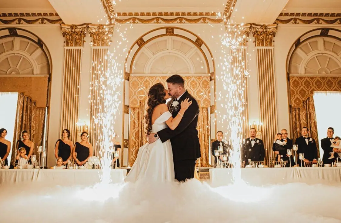 Michael and Shelly’s first dance with cold sparklers and fog in a gold ballroom